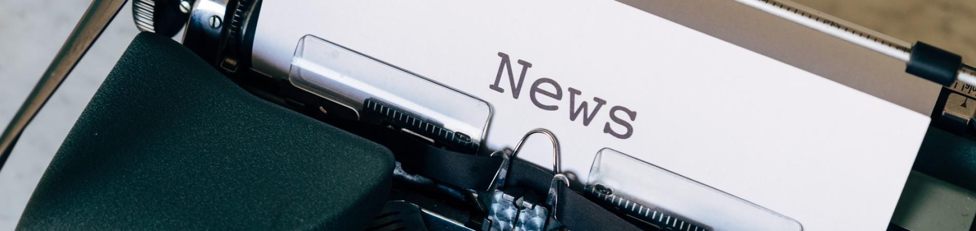 Typewriter with paper titled "News" inserted.