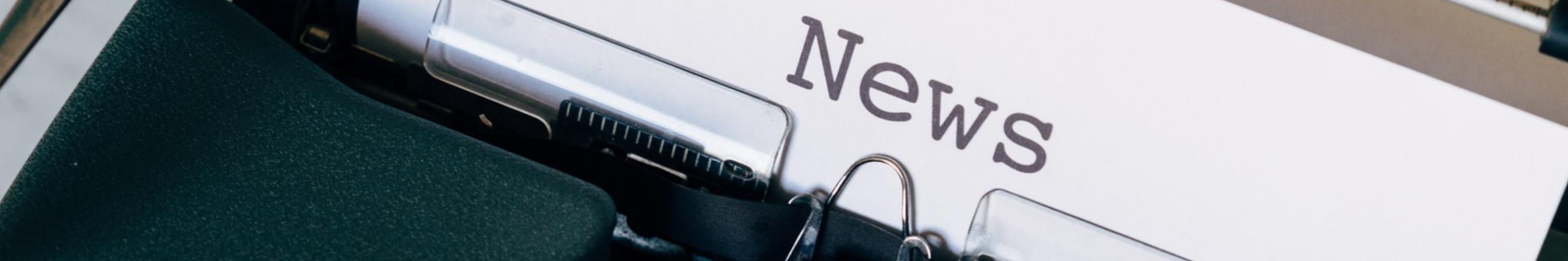 Typewriter with a sheet of paper showing the word "News".